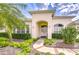 Inviting front entrance with double doors and mature landscaping at 4304 Place Le Manes, Lutz, FL 33558