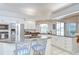 Eat-in kitchen with granite counters, stainless appliances, tile floors, and island with cooktop at 4304 Place Le Manes, Lutz, FL 33558
