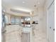 Bright, open kitchen with a center island, stainless steel appliances, and ample cabinet space at 4304 Place Le Manes, Lutz, FL 33558