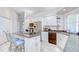Kitchen featuring an island with cooktop, tile flooring, stainless appliances, and ample cabinet space at 4304 Place Le Manes, Lutz, FL 33558