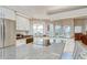 Bright kitchen with island cooktop, stainless appliances, granite counters, and lots of natural light at 4304 Place Le Manes, Lutz, FL 33558