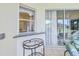 The pass-through window and sliding glass doors in the lanai connect the indoors with the outdoors at 4304 Place Le Manes, Lutz, FL 33558