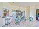 Covered lanai boasts tile flooring and an outdoor seating area with beautiful views at 4304 Place Le Manes, Lutz, FL 33558