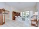 Elegant living room featuring tile floors, a bookshelf, and sliding glass doors to the outdoor patio at 4304 Place Le Manes, Lutz, FL 33558
