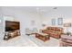 Cozy living room features a comfortable leather sofa, floral chairs, and natural lighting at 4304 Place Le Manes, Lutz, FL 33558