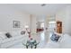 Bright living room with neutral colors, large sofa, decorative pillows, and view to the foyer at 4304 Place Le Manes, Lutz, FL 33558