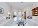 Inviting living room with neutral colors, comfortable sofa, and open view to the foyer and dining room at 4304 Place Le Manes, Lutz, FL 33558