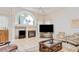 Bright living room with large windows, fireplace, flat screen TV, and decorative accents at 4304 Place Le Manes, Lutz, FL 33558