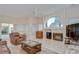 Bright and airy living room with fireplace, large windows, tile flooring, and comfortable seating at 4304 Place Le Manes, Lutz, FL 33558