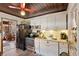 Well-equipped kitchen with stainless steel appliances, white cabinetry, and rustic wood-paneled ceiling at 44 77Th Ave, Treasure Island, FL 33706