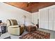 Relaxing living room with a recliner, wooden ceiling, and a view of the spacious closet at 44 77Th Ave, Treasure Island, FL 33706