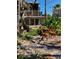 Charming outdoor seating area with decorative chairs surrounded by lush tropical plants and a unique stone walkway at 44 77Th Ave, Treasure Island, FL 33706