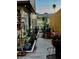Enchanting side yard garden adorned with decorative plants and garden art, leading to a serene outdoor retreat at 44 77Th Ave, Treasure Island, FL 33706