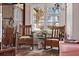 Cozy sitting area with vintage chairs and a beautiful stained-glass window adding to the charm at 44 77Th Ave, Treasure Island, FL 33706