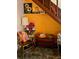 Cozy reading nook under the stairs featuring vintage decor, artwork, and warm ambient lighting at 44 77Th Ave, Treasure Island, FL 33706
