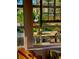 Charming window view featuring decorative glass, a flamingo sculpture, and glimpses of the verdant outdoor scenery at 44 77Th Ave, Treasure Island, FL 33706