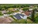 Aerial view of a charming two-story home featuring a private screened-in pool and lush landscaping at 4505 Anaconda Dr, New Port Richey, FL 34655