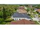 Aerial view highlights a pristine home, a screened-in pool, a patio and manicured landscaping at 4505 Anaconda Dr, New Port Richey, FL 34655
