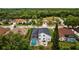 Aerial view showcases a private pool, patio with fire pit, and lush landscaping surrounding the property at 4505 Anaconda Dr, New Port Richey, FL 34655