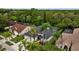 Aerial view of a landscaped home featuring a dark roof, palm trees, and a pool, showcasing the property's features at 4505 Anaconda Dr, New Port Richey, FL 34655