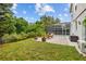 Serene backyard featuring a patio area, lush landscaping, and a screened pool enclosure, perfect for relaxation at 4505 Anaconda Dr, New Port Richey, FL 34655
