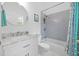 Modern bathroom with a white vanity, marble countertop, and gray tiled shower at 4505 Anaconda Dr, New Port Richey, FL 34655
