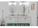 Bright bathroom with double vanity, granite countertop, and decorative storage baskets at 4505 Anaconda Dr, New Port Richey, FL 34655