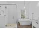 Contemporary bathroom featuring a glass shower, a soaking tub, and elegant vanity at 4505 Anaconda Dr, New Port Richey, FL 34655