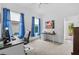 Bright bedroom with a modern desk and chair, with natural light and vibrant artwork at 4505 Anaconda Dr, New Port Richey, FL 34655