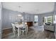 Bright dining room with a modern chandelier and ample space for entertaining, flowing into the living area at 4505 Anaconda Dr, New Port Richey, FL 34655