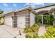 Close-up of a charming front entrance with manicured plants leading to a classic black front door at 4505 Anaconda Dr, New Port Richey, FL 34655