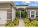 Inviting front entryway adorned with lush landscaping and a covered porch, creating a warm welcome at 4505 Anaconda Dr, New Port Richey, FL 34655