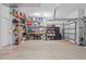 Spacious garage with ample storage, including shelving and cabinets for organized tools and equipment at 4505 Anaconda Dr, New Port Richey, FL 34655