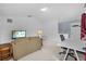 Bright upstairs living area featuring a sofa, workspace, and comfortable seating at 4505 Anaconda Dr, New Port Richey, FL 34655
