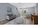 Bright and open living room featuring wood floors, a sofa, and a dining area with bright natural light at 4505 Anaconda Dr, New Port Richey, FL 34655