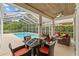Screened-in pool with an outdoor seating area and lush landscaping at 4505 Anaconda Dr, New Port Richey, FL 34655