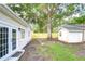 Large backyard featuring grass and fence, offering privacy for outdoor enjoyment at 4605 W Loughman St, Tampa, FL 33616