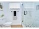 Bathroom with updated fixtures, sleek glass shower, and modern toilet at 4605 W Loughman St, Tampa, FL 33616