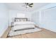 A serene main bedroom featuring a plush bed, ample closet space, and a ceiling fan at 4605 W Loughman St, Tampa, FL 33616