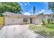 Beautiful one-story home featuring an attached garage, new landscaping, and a modern front door at 4605 W Loughman St, Tampa, FL 33616
