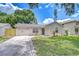 Charming single-story home features a well-manicured lawn, attached garage and inviting modern entrance at 4605 W Loughman St, Tampa, FL 33616
