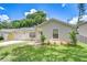 Cozy one-story home with an attached garage, neatly landscaped yard, and a welcoming modern entrance at 4605 W Loughman St, Tampa, FL 33616