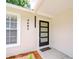 Contemporary front door with glass panes, a welcome mat, and modern house numbers at 4605 W Loughman St, Tampa, FL 33616