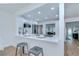 Bright eat-in kitchen with white cabinets, stainless steel appliances, and breakfast bar at 4605 W Loughman St, Tampa, FL 33616
