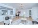 Open-concept living area featuring hardwood floors, modern lighting, a breakfast bar, and dining area at 4605 W Loughman St, Tampa, FL 33616