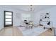 Bright living room boasts natural light, hardwood floors, modern lighting, and designer furnishings at 4605 W Loughman St, Tampa, FL 33616
