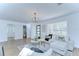 Comfortable living room offering a seamless flow, hardwood floors, updated lighting, and stylish decor at 4605 W Loughman St, Tampa, FL 33616