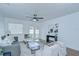 Cozy living room with a ceiling fan, neutral decor, and double doors leading to the exterior at 4605 W Loughman St, Tampa, FL 33616