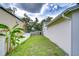 A well-maintained side yard between two homes with a lush green lawn at 4605 W Loughman St, Tampa, FL 33616