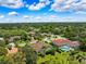 Expansive aerial view of a luxurious community featuring lush landscaping and stunning homes with private pools at 5904 Pelican Bay S Plz, Gulfport, FL 33707